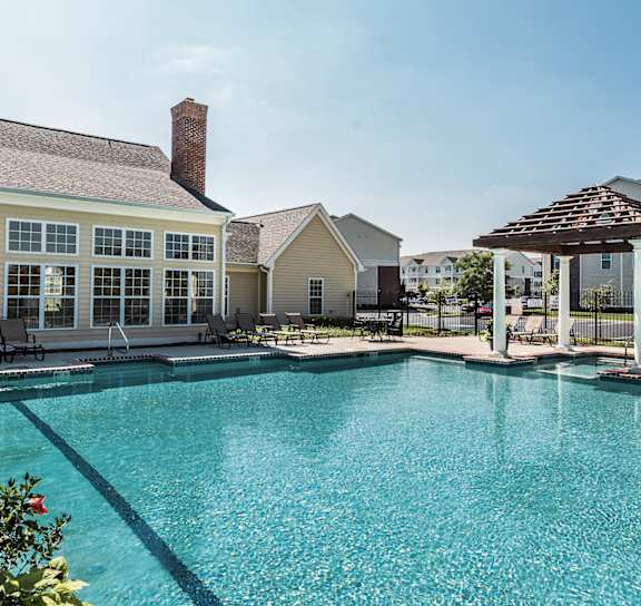 a large swimming pool with apartments in the background at Brickshire Apartments, Merrillville, IN