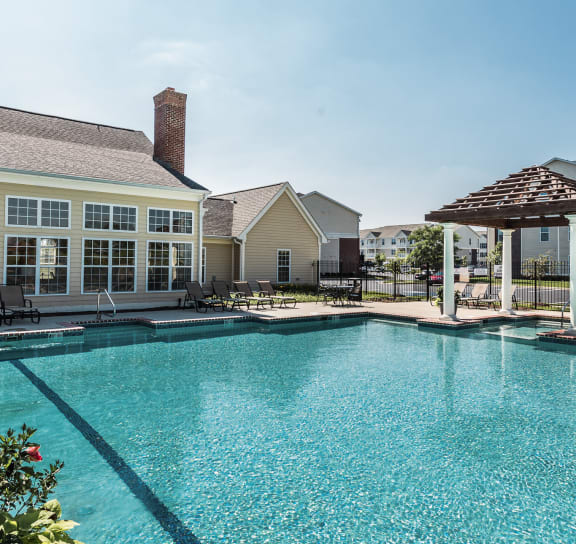 a large swimming pool with apartments in the background at Brickshire Apartments, Merrillville, IN