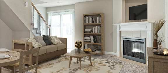 a living room with a dining room table and a fireplace