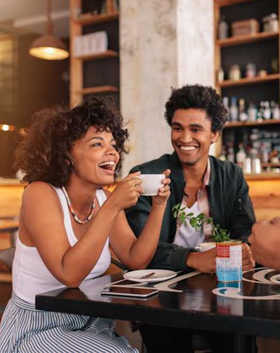 Four people are sitting at a table in a restaurant.