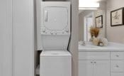 Thumbnail 11 of 15 - a white washer and dryer in a bathroom