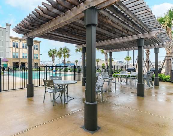 The sundeck at the swimming pool at Villas on the Strand apartments in Galveston, TX