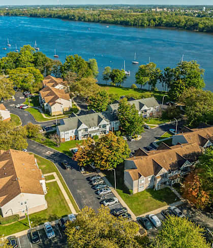 an aerial view of a neighborhood with a lake in the background