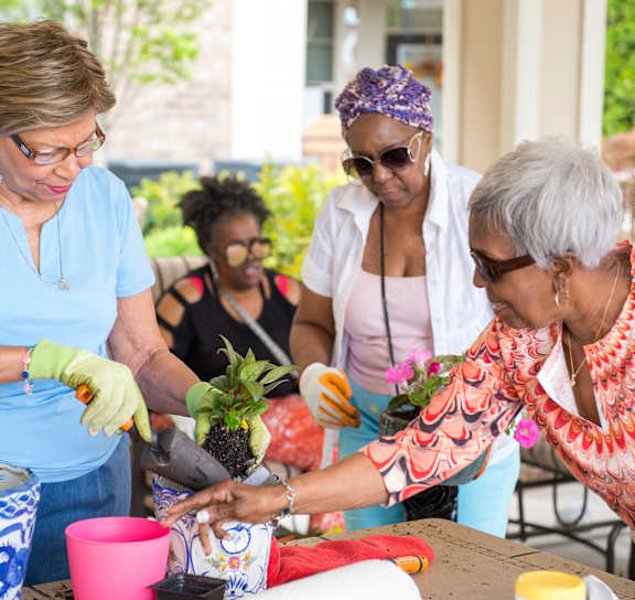 a group of women working in a garden