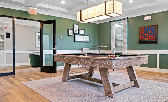 a game room with a pool table and a dining area at Edgebrook Residences, New Hampshire, 03054