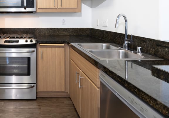 a kitchen with stainless steel appliances and wooden cabinets