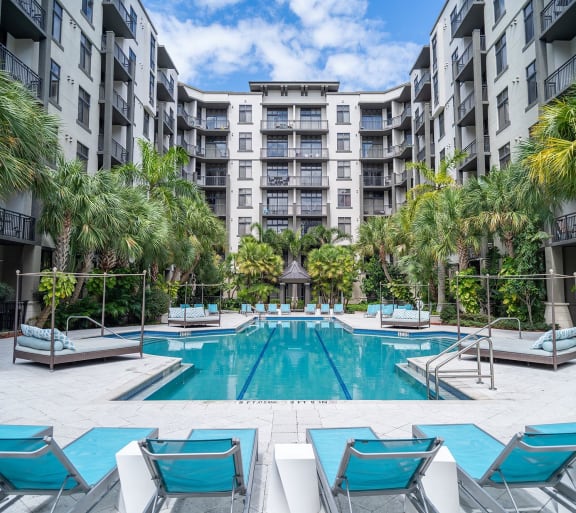 a large swimming pool in front of an apartment building
