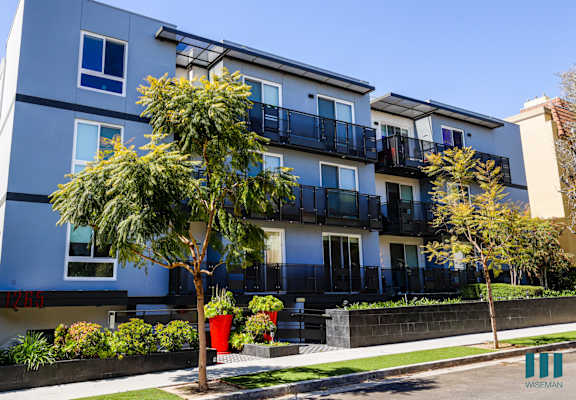 a blue and white building with trees in front of it