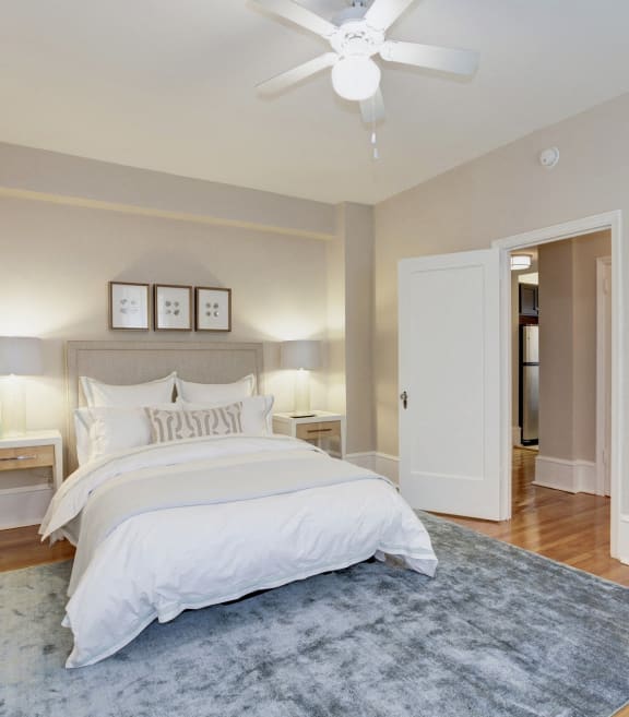 a bedroom with a bed and a ceiling fan