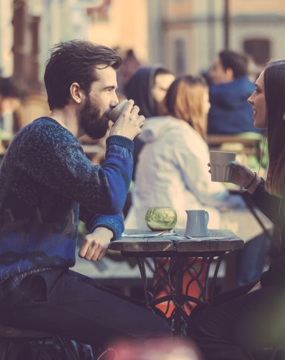 couple sharing coffee nearby the liberty town-homes in golden valley mn