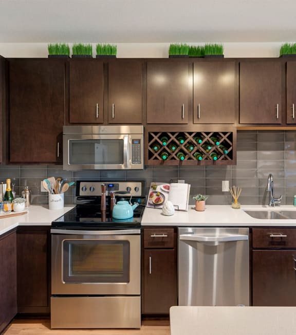 a modern kitchen with stainless steel appliances and wooden cabinets