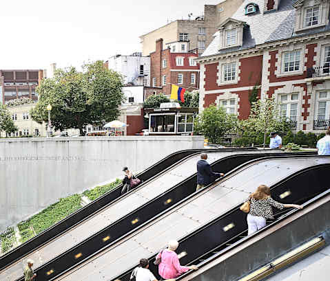 people on the escalators at the subway station