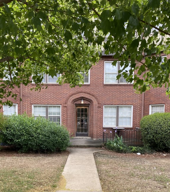 a view of a brick building from above with trees