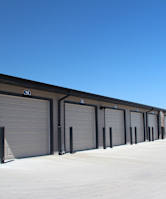 A long row of garage doors are closed.