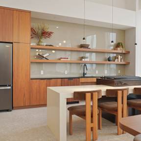 A modern kitchen with a large island and a view of the city.