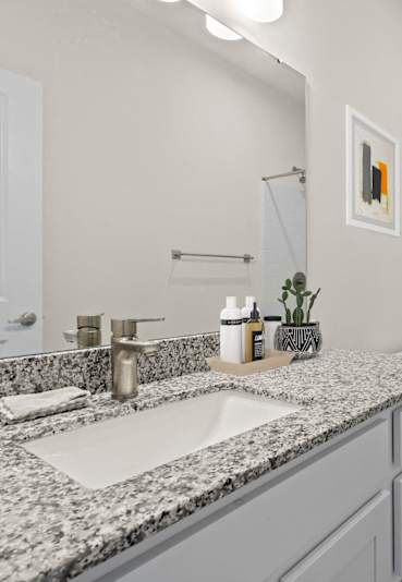 A bathroom with a sink, toilet, and shower.