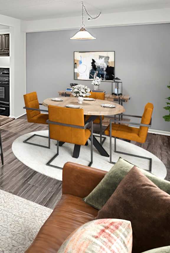 A living room with a couch, chairs, and a coffee table.
