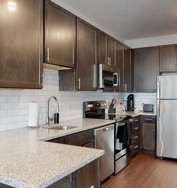 a kitchen with stainless steel appliances and granite counter tops