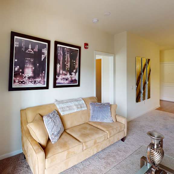 an open concept living room and dining area with a white dining table and rattan chairs