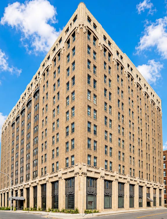 A large, beige, rectangular building with many windows and a flat roof.