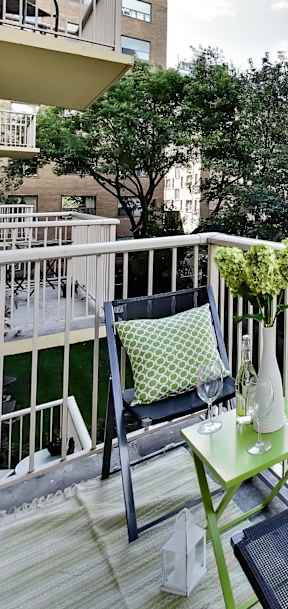 a living room with a couch and a table on a balcony