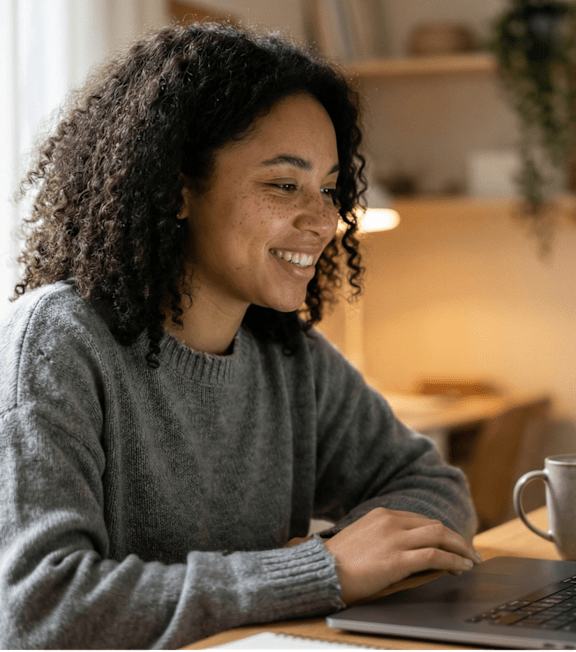 Woman using laptop at Wheelhouse Lofts, Ohio, 45402
