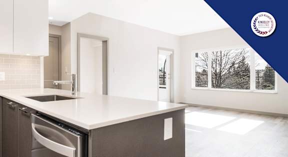 A modern kitchen with a stainless steel oven and dishwasher.