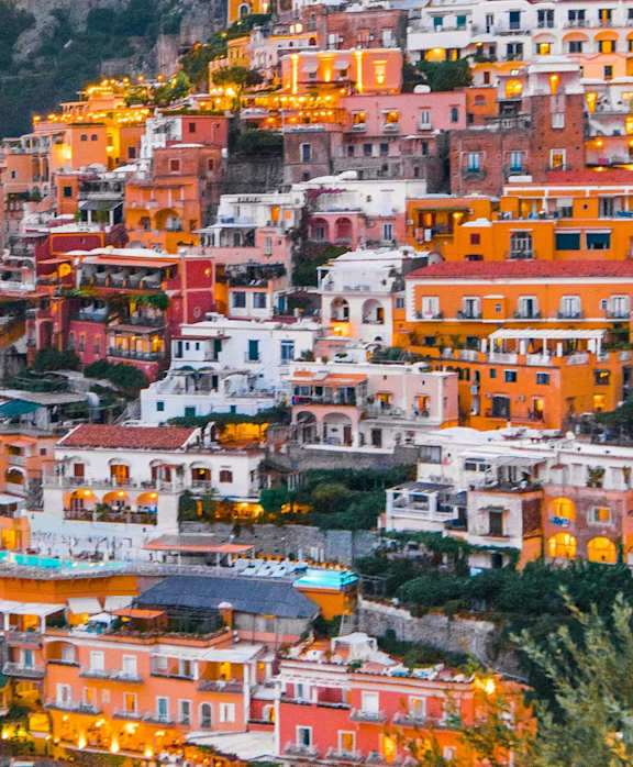 A beautiful coastal town with colorful buildings and boats in the water.