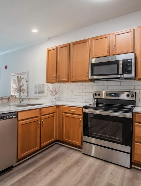 A kitchen with wooden cabinets and stainless steel appliances.