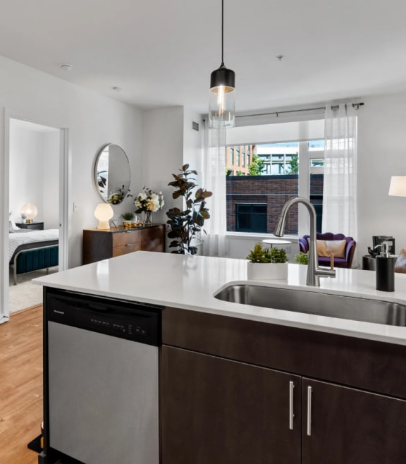 a kitchen with a sink and a door to a living room at The Parker in Portland, Oregon