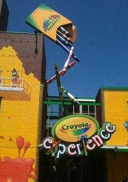 a sign on the side of a yellow building