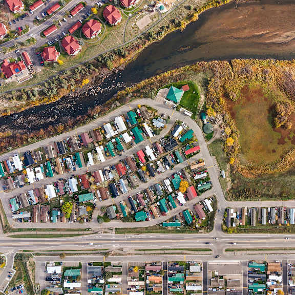 A bird's eye view of a residential area with houses and a river.
