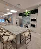 A modern kitchen with a dining table and chairs.