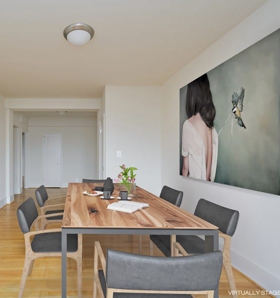 a dining room with a wooden table and grey chairs at 1841 Columbia Road Apartments, Washington, Washington DC