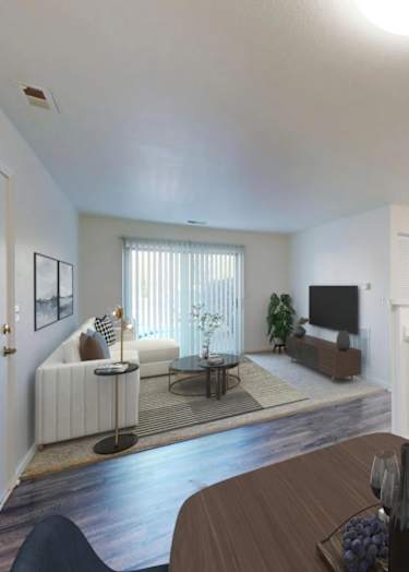 A modern living room with a dining area and kitchen in the background.