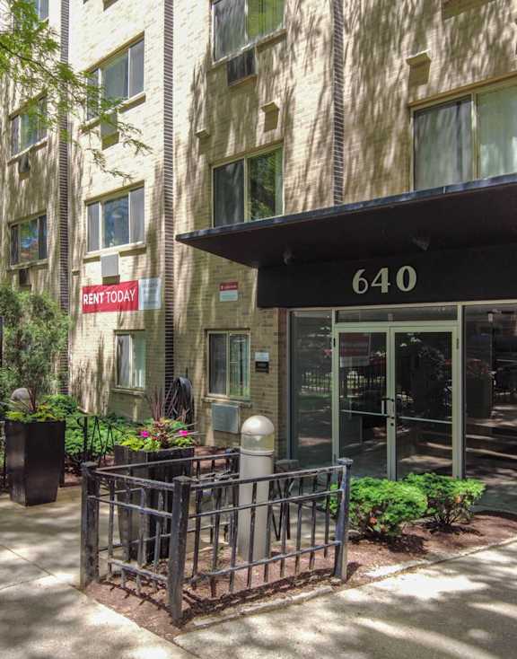 an apartment building with a large entrance and a sign that says 6410