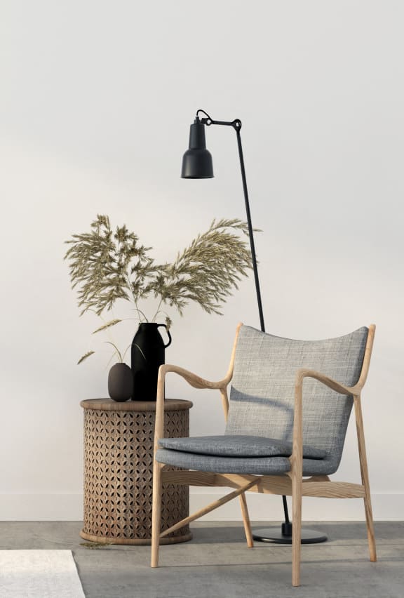 a living room with a chair and a lamp