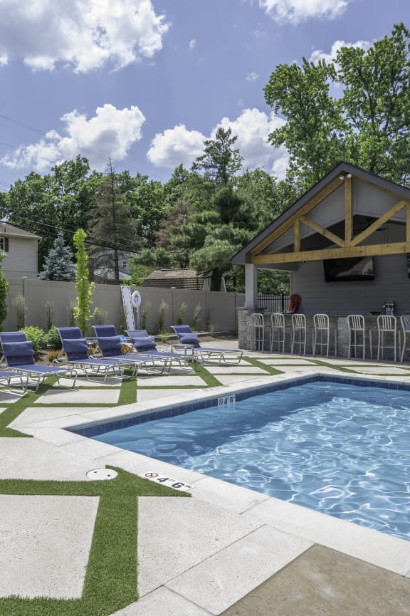 a swimming pool in front of a house with lounge chairs at Olde Towne in Kenwood, Cincinnati, OH, 45243