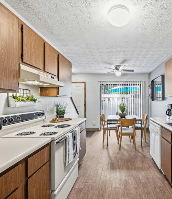 A kitchen with wooden cabinets and a white countertop.