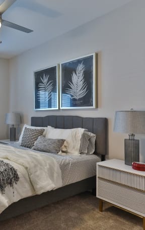 a bedroom with a large bed and a ceiling fan