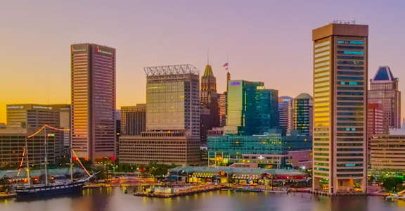 the skyline of the city at sunset with the harbor and the city s skyline