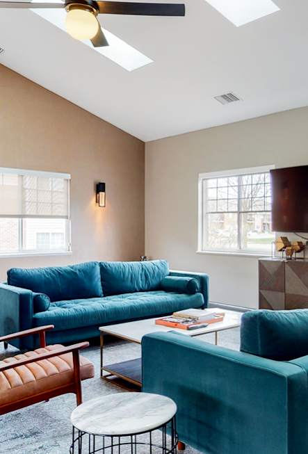A living room with a blue couch and a television.
