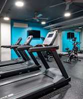 A gym with treadmills and exercise bikes.