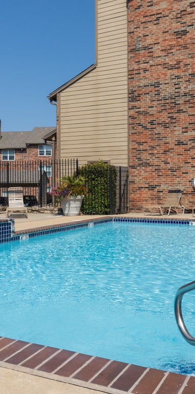 A sparkling pool with lounge chairs and umbrellas for a relaxing afternoon.