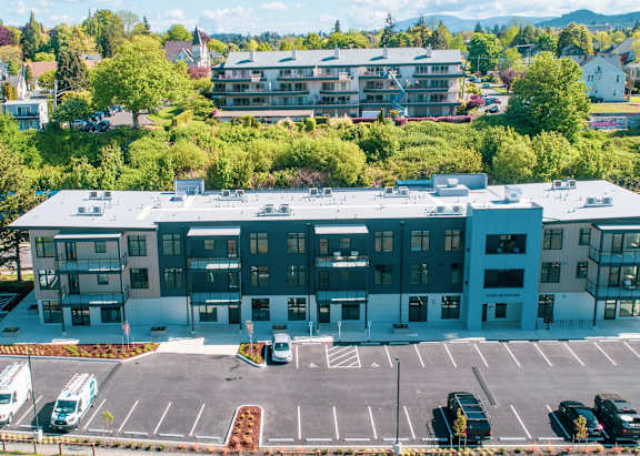 A large building with a parking lot in front of it.