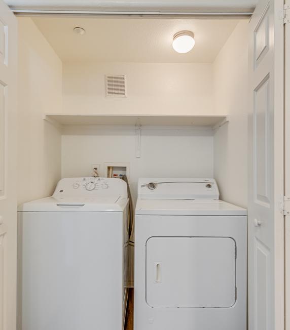 A small laundry room with two washing machines.