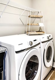 a front loading washer and dryer in a laundry room