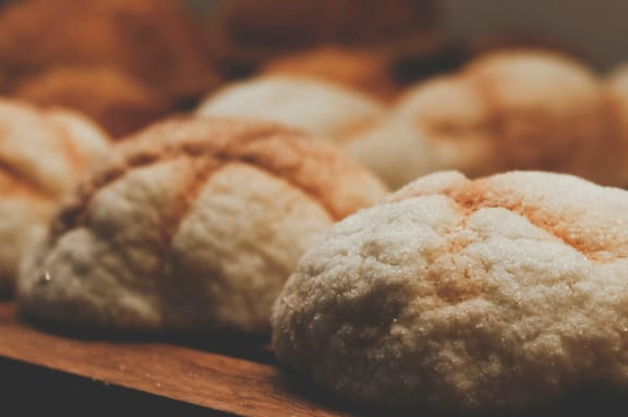 a pile of freshly baked croissants on a wooden table at South Falls Tower, Richmond, VA, 23224
