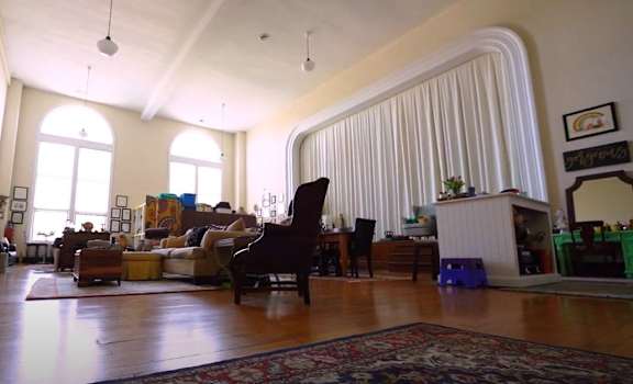 a living room filled with furniture and a large window