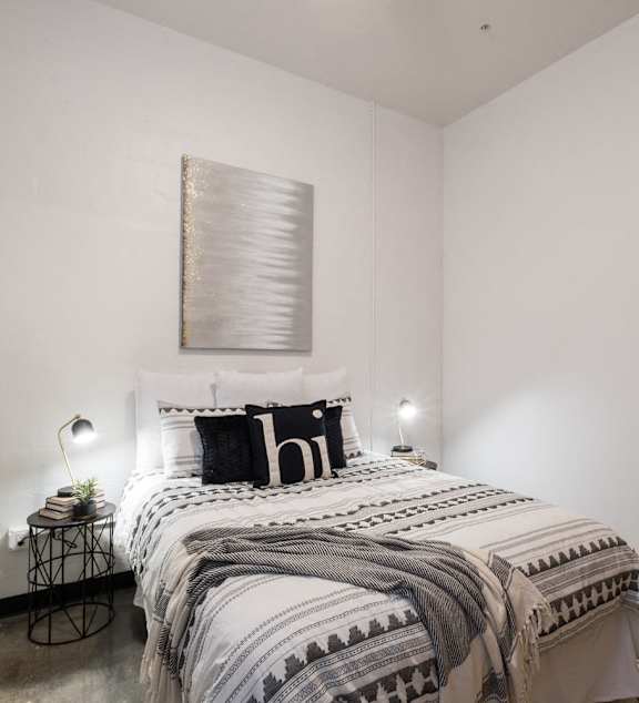 a bedroom with a large bed and a ceiling fan